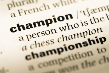 Obraz premium Close up of old English dictionary page with word champion
