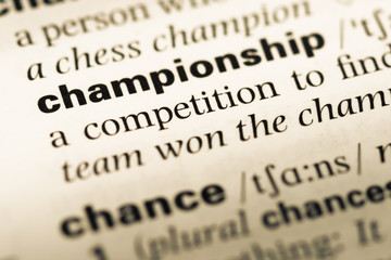 Obraz premium Close up of old English dictionary page with word championship