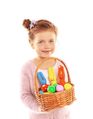 Fototapeta na wymiar Little girl holding wicker basket with Easter eggs and rabbits isolated on white