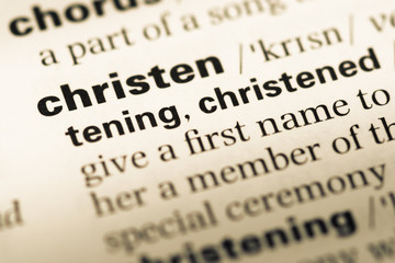 Obraz premium Close up of old English dictionary page with word christen