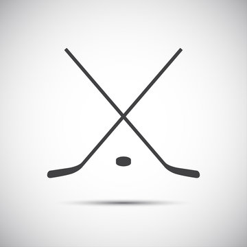 Simple crossed hockey stick with puck, vector icon