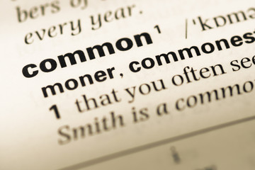 Close up of old English dictionary page with word common