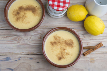 Traditional creme brulee on ceramic dish on wooden table