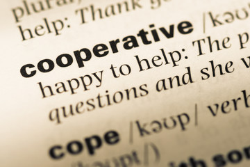 Close up of old English dictionary page with word cooperative