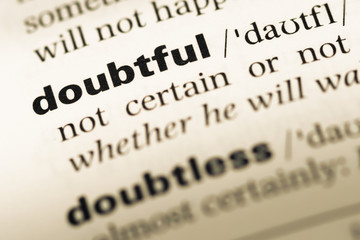 Fototapeta premium Close up of old English dictionary page with word doubtful