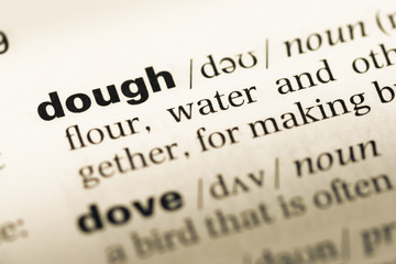 Close up of old English dictionary page with word dough