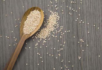 quinoa seeds on a rustic wooden background.