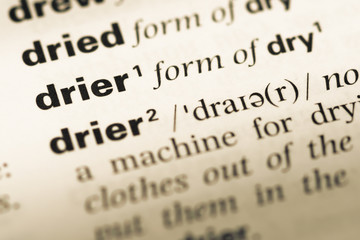 Obraz premium Close up of old English dictionary page with word drier
