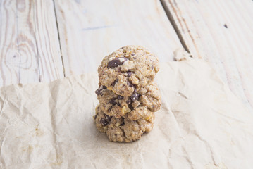 Chocolate cookies on white linen napkin on wooden table