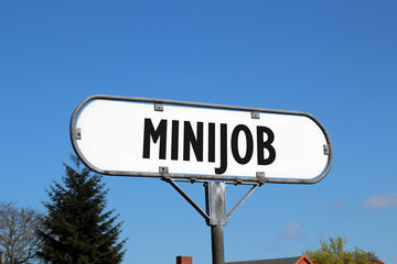 Fototapeta premium minijob - old white sign on blue sky background