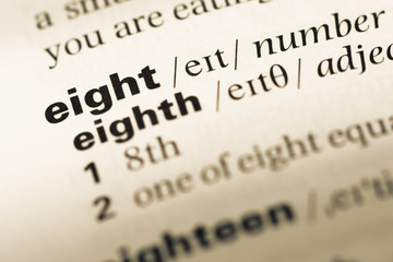 Obraz premium Close up of old English dictionary page with word eight