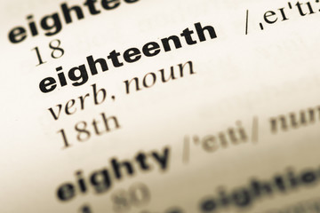 Close up of old English dictionary page with word eighteenth