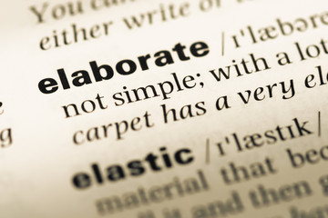 Obraz premium Close up of old English dictionary page with word elaborate