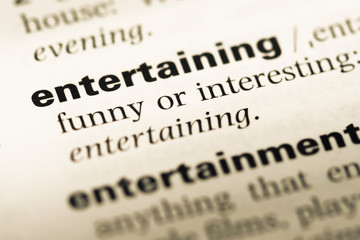 Obraz premium Close up of old English dictionary page with word entertaining