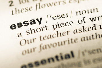 Close up of old English dictionary page with word essay - obrazy, fototapety, plakaty