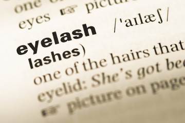 Fototapeta premium Close up of old English dictionary page with word eyelash