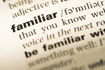 Close up of old English dictionary page with word familiar