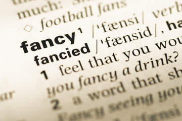Fototapeta premium Close up of old English dictionary page with word fancy