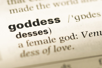 Obraz premium Close up of old English dictionary page with word goddess