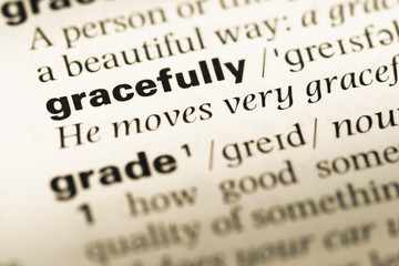 Fototapeta premium Close up of old English dictionary page with word gracefully