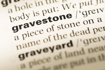 Close up of old English dictionary page with word gravestone