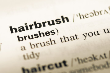 Obraz premium Close up of old English dictionary page with word hairbrush