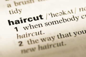 Obraz premium Close up of old English dictionary page with word haircut