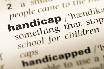 Obraz premium Close up of old English dictionary page with word handicap