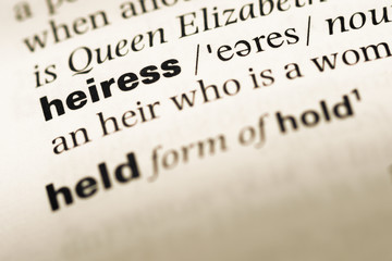 Close up of old English dictionary page with word heiress