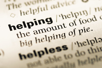 Obraz premium Close up of old English dictionary page with word helping