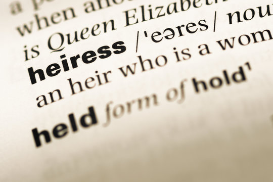 Close up of old English dictionary page with word heiress