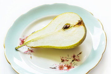 Pear on a plate, light background