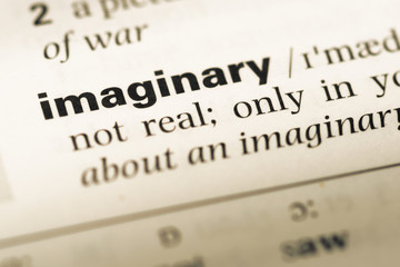 Close up of old English dictionary page with word imaginary