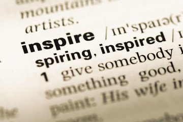 Fototapeta premium Close up of old English dictionary page with word inspire