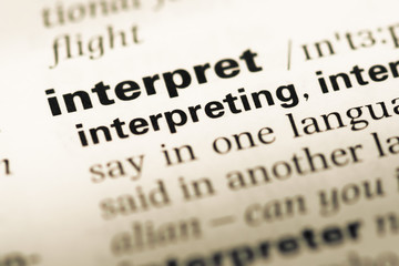 Close up of old English dictionary page with word interpret