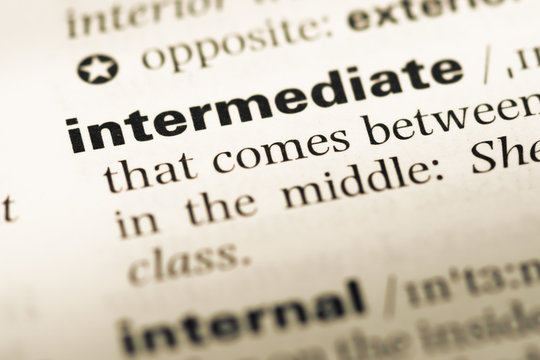 Close up of old English dictionary page with word intermediate