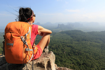 successful woman hiker enjoy the view on mountain top