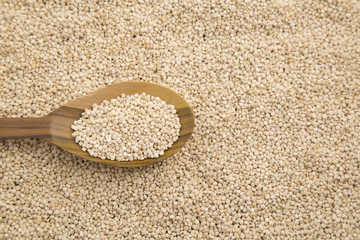 quinoa seeds on a rustic wooden background.