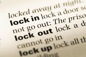 Obraz premium Close up of old English dictionary page with word lock in