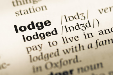 Fototapeta premium Close up of old English dictionary page with word lodge