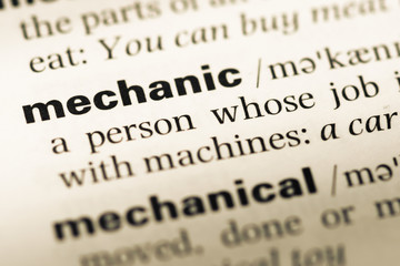 Obraz premium Close up of old English dictionary page with word mechanic