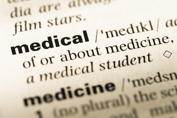 Obraz premium Close up of old English dictionary page with word medical