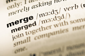 Close up of old English dictionary page with word merge