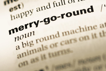 Close up of old English dictionary page with word merry go round