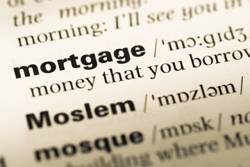 Obraz premium Close up of old English dictionary page with word mortgage