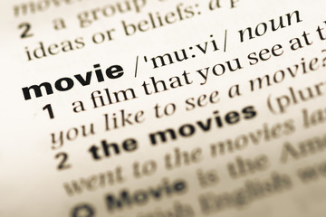 Fototapeta premium Close up of old English dictionary page with word movie
