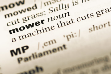Close up of old English dictionary page with word mower
