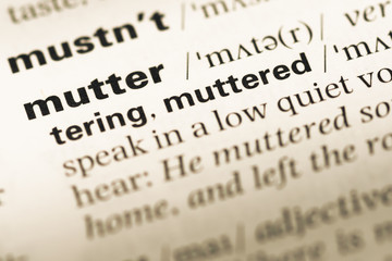 Close up of old English dictionary page with word mutter