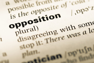 Close up of old English dictionary page with word opposition