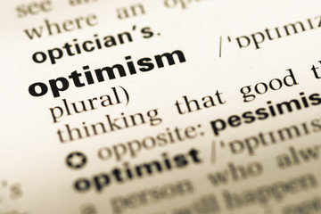 Close up of old English dictionary page with word optimism - obrazy, fototapety, plakaty
